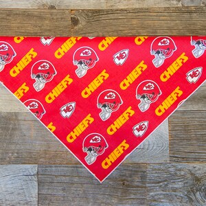 May include: Red triangular bandana with a white border and a repeating pattern of yellow "CHIEFS" text and a football helmet graphic.