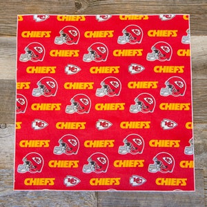 May include: Red fabric with a repeating pattern of yellow "CHIEFS" text and a red and white football helmet graphic.