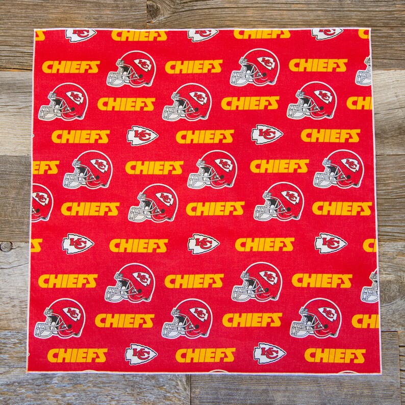 May include: Red fabric with a repeating pattern of yellow "CHIEFS" text and a red and white football helmet graphic.