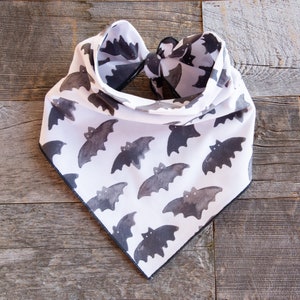 May include: White bandana with a black border and a repeating pattern of black bats.