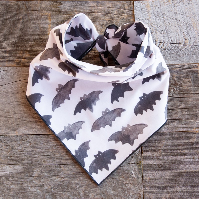 May include: White bandana with a black border and a repeating pattern of black bats.
