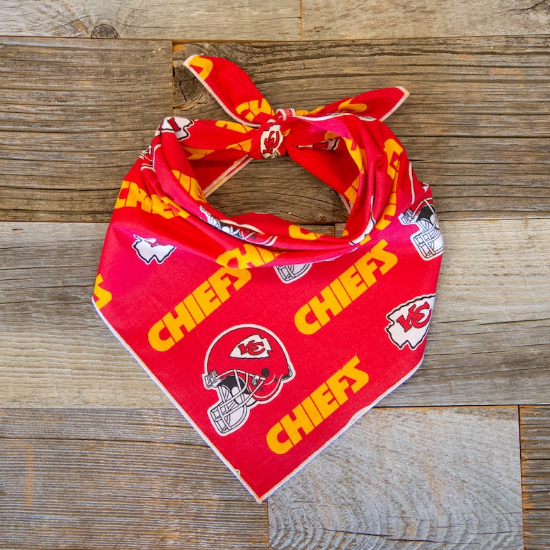 May include: Red bandana with a white and yellow pattern featuring the Kansas City Chiefs logo and the word "Chiefs" repeated throughout.