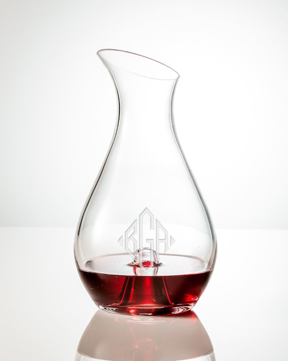Hand-engraved crystal decanter with custom monogram — the kind of personalized barware that actually looks expensive on a home bar cart.