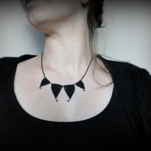 Black woven macrame necklace adorned with brass beads. Statement piece for everyday. Simple but unique!