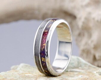 May include: A silver band with a purple and gold inlay. The band is smooth and polished.