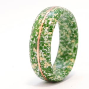 May include: A green and white speckled ring with a thin copper band around the center.
