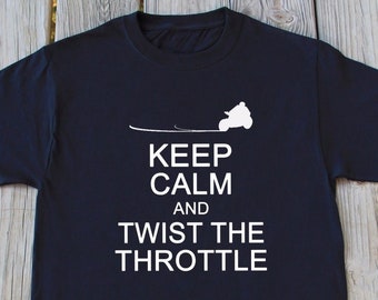 May include: Black t-shirt with a white graphic of a person riding an ATV with the text "Keep Calm and Twist the Throttle".