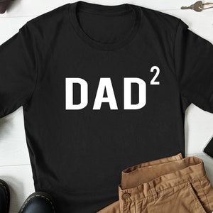 May include: Black t-shirt with white text that reads "DAD²".