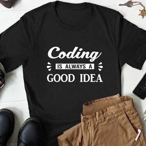 May include: Black t-shirt with white text that reads "Coding is always a good idea".