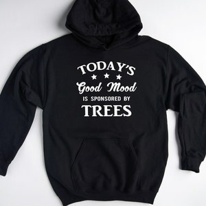 May include: Black hooded sweatshirt with white text that reads "TODAY'S Good Mood IS SPONSORED BY TREES".