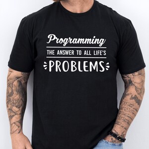 May include: Black t-shirt with white text that reads "Programming The Answer To All Life's PROBLEMS"