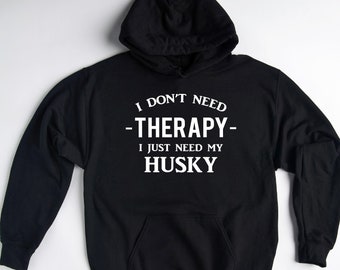 May include: Black hooded sweatshirt with white text that reads "I don't need -therapy- I just need my husky".