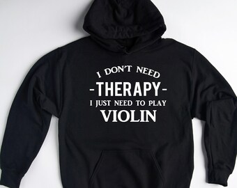 May include: Black hoodie with white text that reads "I don't need -therapy- I just need to play violin".