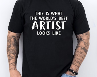 May include: A black t-shirt with white text that reads "This is what the world's best artist looks like."