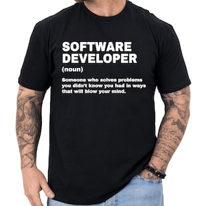 May include: Black t-shirt with the text "SOFTWARE DEVELOPER (noun) Someone who solves problems you didn't know you had in ways that will blow your mind." The text is in white, centered on the shirt.