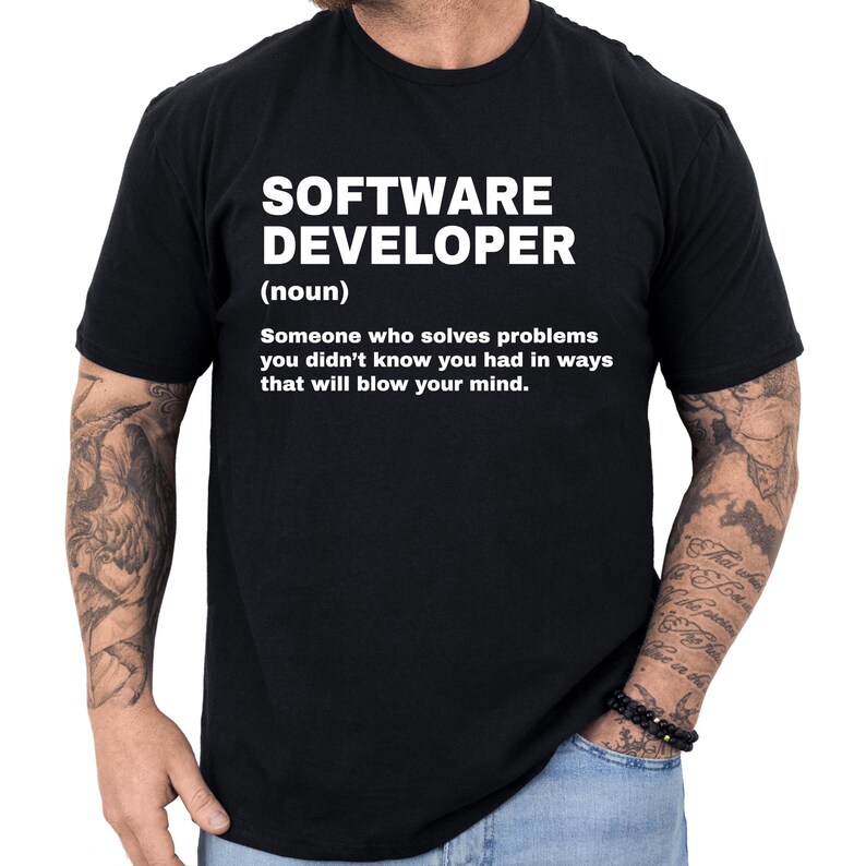 May include: Black t-shirt with the text "SOFTWARE DEVELOPER (noun) Someone who solves problems you didn't know you had in ways that will blow your mind." The text is in white, centered on the shirt.