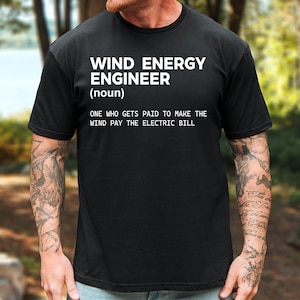 May include: A black short-sleeved t-shirt featuring white text that reads WIND ENERGY ENGINEER (noun) ONE WHO GETS PAID TO MAKE THE WIND PAY THE ELECTRIC BILL. The shirt has a crew neckline and a standard fit, displaying the printed text clearly.