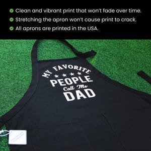 May include: Black apron with white text that reads "My Favourite People Call Me Dad" with four stars above the word "People".