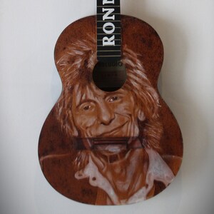 Ronnie Wood. Pyrography guitar. Pyrography. Woodburnig acoustic guitar. Decorated rock and roll rolling stones guitar