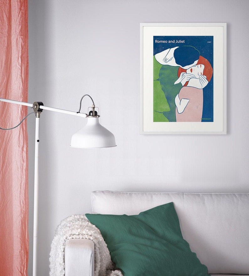 May include: A framed poster with a blue, green, and pink illustration of a couple embracing. The poster has the title "Romeo and Juliet" printed at the top.