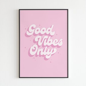 May include: A pink framed print with the text "Good Vibes Only" in white, stylized lettering.