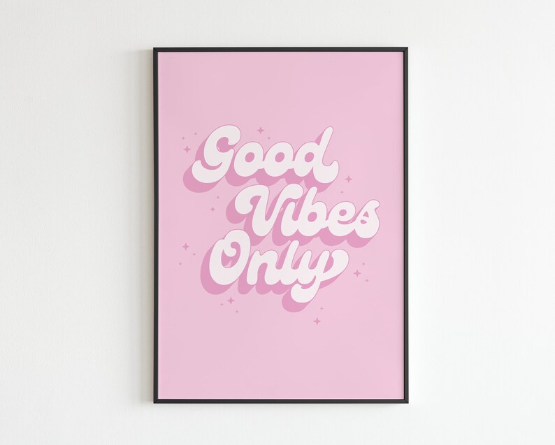May include: A pink framed print with the text "Good Vibes Only" in white, stylized lettering.