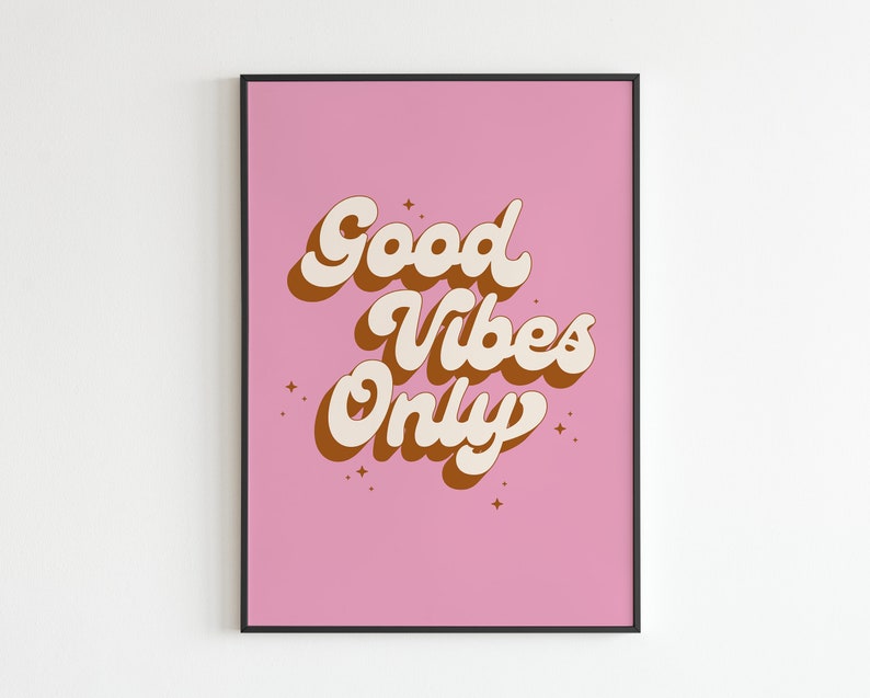 May include: A pink poster with the text "Good Vibes Only" in a retro font style. The text is in white with brown outlines. There are small white stars scattered around the text.