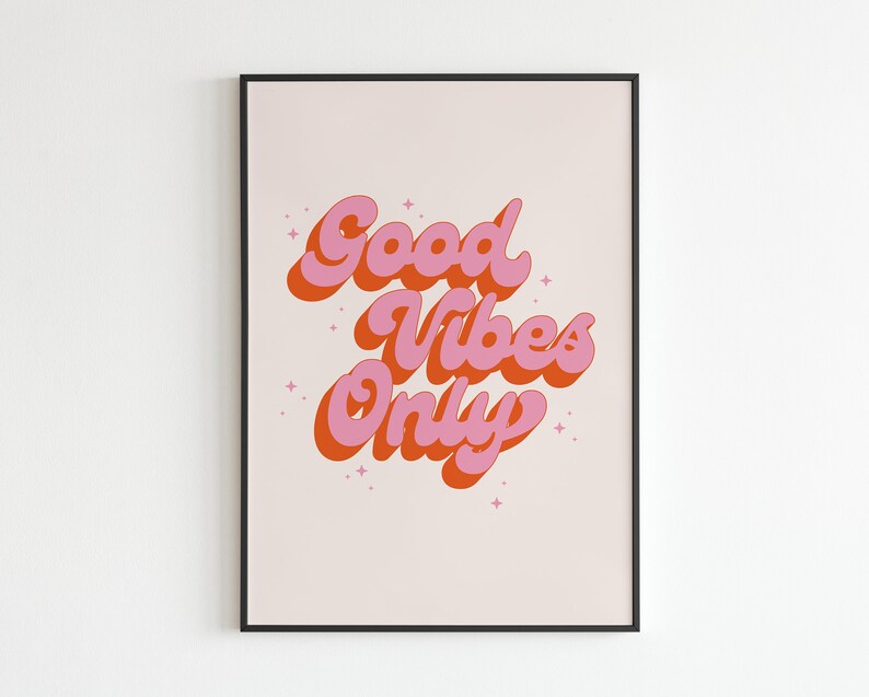 May include: A framed print with a pink and orange retro-style graphic that says "Good Vibes Only" on a light pink background.