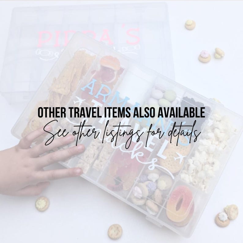 May include: A clear plastic storage box filled with various snacks, including pretzels, popcorn, and gummies. The box has a label that says "Travel Snacks". The text "OTHER TRAVEL ITEMS ALSO AVAILABLE See other listings for details" is written on the image.