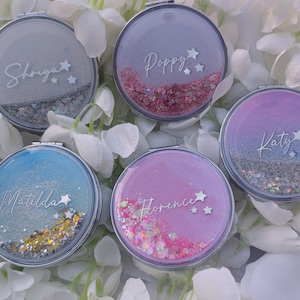 May include: Five round, silver-framed compact mirrors with personalised names and glitter inside. The names are "Poppy", "Shanya", "Matilda", "Florence", and "Katy".