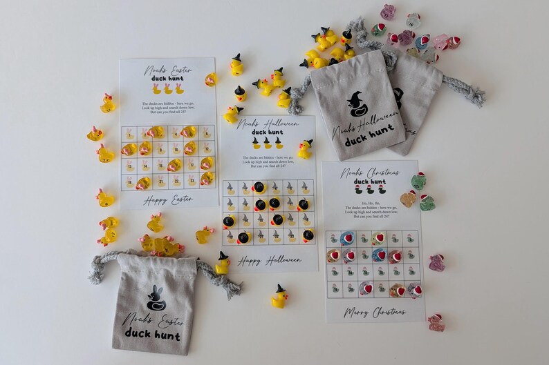 May include: A collection of duck hunt game sets for Easter, Halloween, and Christmas. Each set includes a game card with a grid, small duck figurines, and a drawstring bag. The text "Noah's Easter duck hunt", "Noah's Halloween duck hunt", and "Noah's Christmas duck hunt" is visible.