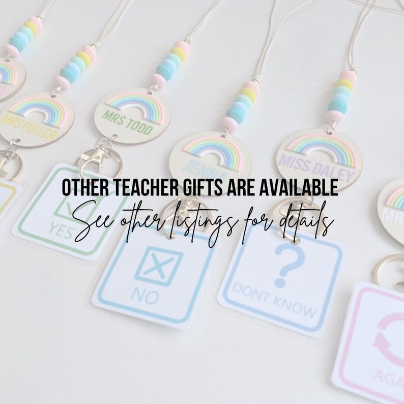 May include: A set of rainbow-themed teacher gifts with personalized name tags. The gifts include a lanyard with colorful beads and a wooden rainbow charm. The image also shows a set of four keychains with different designs, including a checkmark, an X, a question mark, and a circle with an arrow. The text "OTHER TEACHER GIFTS ARE AVAILABLE See other listings for details" is visible in the image.