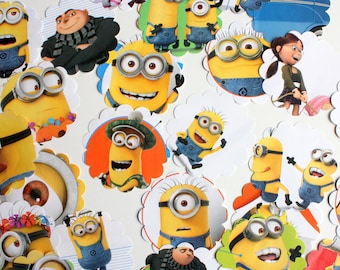 May include: A collection of 17 round, scalloped-edge cupcake toppers featuring various images of the Minions from the Despicable Me franchise. The toppers feature the Minions in different poses and expressions, including some with goggles and overalls.