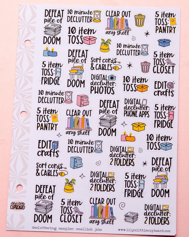 May include: A set of colourful stickers with decluttering tasks and timeframes. The stickers feature illustrations of books, phones, folders, and other household items. The text on the stickers includes phrases like "10 minute declutter", "5 item toss", and "defeat pile of doom".