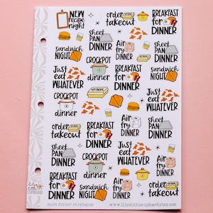May include: A sheet of stickers with various dinner ideas, including "New Recipe Night", "Order Takeaway", "Breakfast for Dinner", "Sheet Pan Dinner", "Air Fry Dinner", "Crockpot Dinner", "Just Eat Whatever", "Sandwich Night", and more. The stickers are colourful and feature illustrations of food and kitchen items.