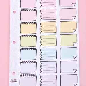 May include: A sheet of colorful note box stickers with a spiral-bound top and lined or blank interiors. The stickers are in pastel shades of pink, yellow, and blue, with a white background and black outlines. The text "essentials - note boxes" and "www.lilyalittlecupboard.com" are at the bottom.