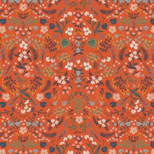 May include: A vibrant floral pattern featuring a symmetrical arrangement of various flowers and foliage. The design includes white, pink, and blue blossoms, along with green leaves and dark blue accents, set against a warm orange-red background. This fabric design is suitable for various craft projects.