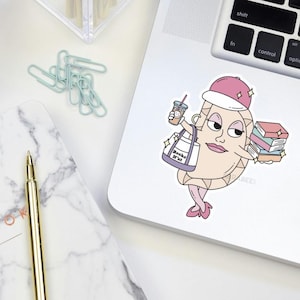 May include: A sticker of a cartoon crescent moon wearing a pink hat and holding a bag that says "Books 'n' that" and a stack of books. The moon is also holding a cup of coffee.