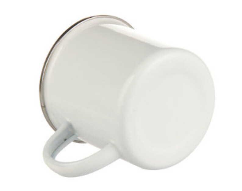 May include: White enamel mug with a silver rim and a handle. The mug is empty.