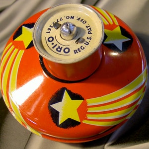 mechanical highspeed tin toy top 1940s