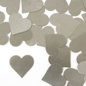 May include: A scattering of silver heart-shaped confetti. The hearts are made of a metallic material and have a shiny finish.