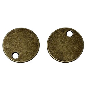 May include: Two antique gold-toned metal round charms with a hole in the center.
