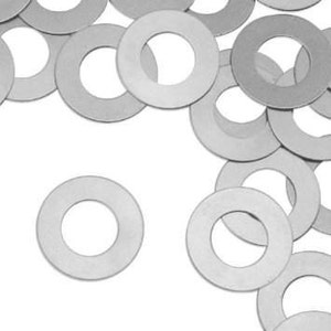 May include: A pile of silver-colored metal washers. The washers are round with a hole in the center.