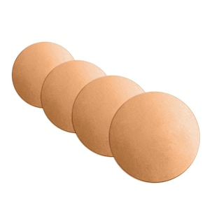 May include: Four round, light brown coasters made of cork or a similar material.