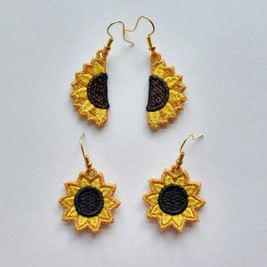 May include: A pair of sunflower earrings. The earrings are made of gold-colored metal and have a sunflower design. The sunflowers are embroidered with yellow and black thread.