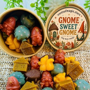 May include: A round cardboard container filled with assorted wax melts shaped like gnomes, houses, and mushrooms in shades of red, orange, yellow, and teal. The lid features a circular label with the text Gnome Sweet Gnome and a house illustration.