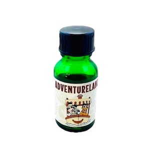 May include: A small green glass bottle with a black lid. The bottle has a white label with the text "Adventureland" and a cartoon image of Mickey Mouse and Pluto on a boat.