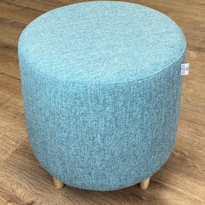 May include: A white ceramic mug with a black handle and the text "But First, Coffee" in a handwritten style. The mug is on a white surface. The mug is likely used for hot beverages.