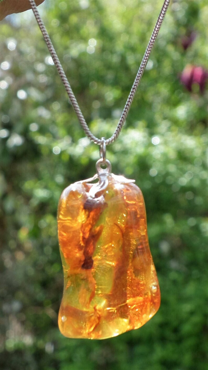 Baltic amber bernstein pendant with silverplated bel cap