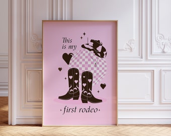 May include: Pink poster with a pair of brown cowboy boots, a pink and white checkered circle, a brown cowboy hat, and the text "This is my first rodeo."